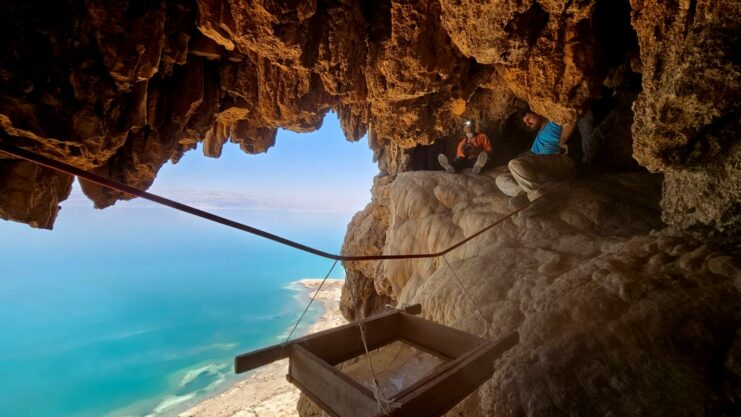 Two archaeologists sitting in a cave