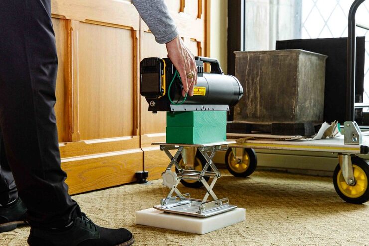 Man operating a machine in front of the time capsule discovered at West Point