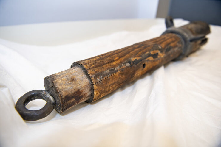 Wooden spar from the USS Maine (1889) placed on a white cloth