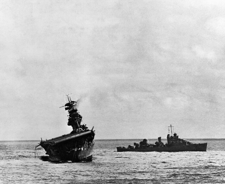 Destroyer sailing toward a listing USS Yorktown (CV-5) during the Battle of Midway
