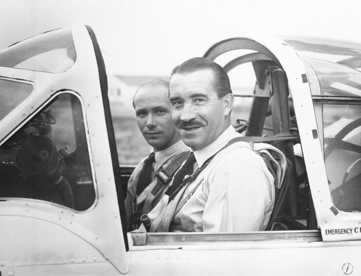 Adolf Galland sitting in the cockpit of an aircraft with another man