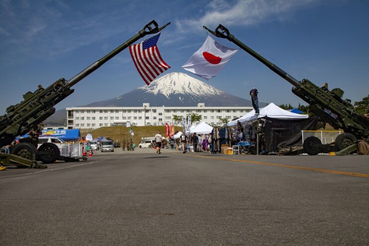 Two M777 howitzers displaying the American and Japanese flags at the Combined Arms Training Center (CATC) Camp Fuji