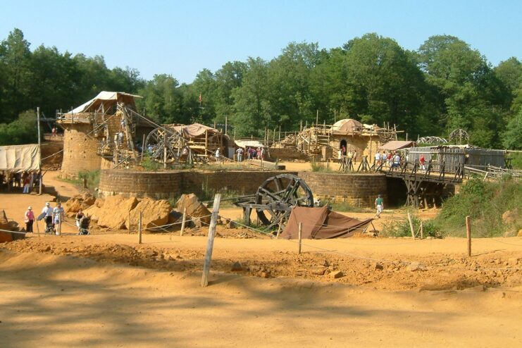 Workers walking around the construction site at Guédelon Castle