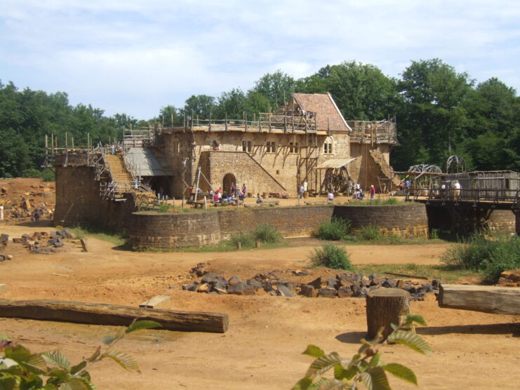 Tourists walking around the site at Guédelon Castle