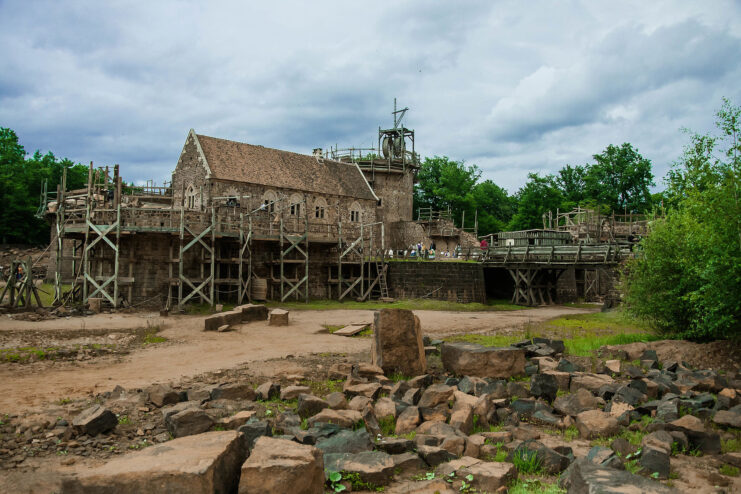 Tourists standing around the exterior of Guédelon Castle