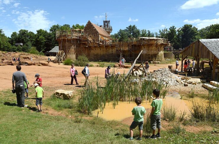 Tourists walking around the construction site at Guédelon Castle