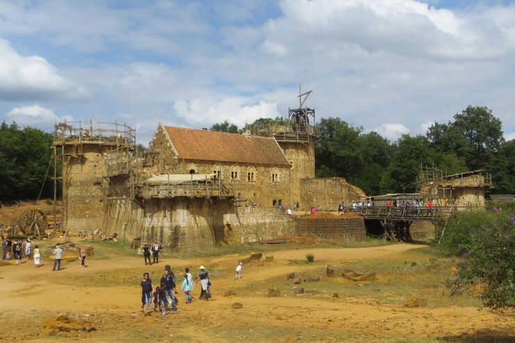 Tourists walking around the construction site at Guédelon Castle