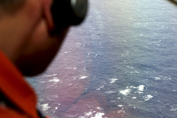 Kazuhiko Morisawa looking out the window of a Gulfstream aircraft