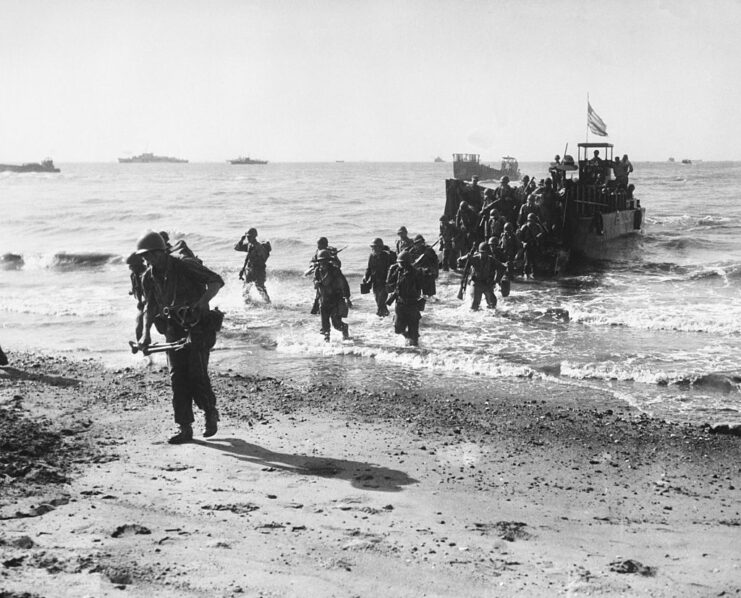 US troops advancing to shore from a landing craft