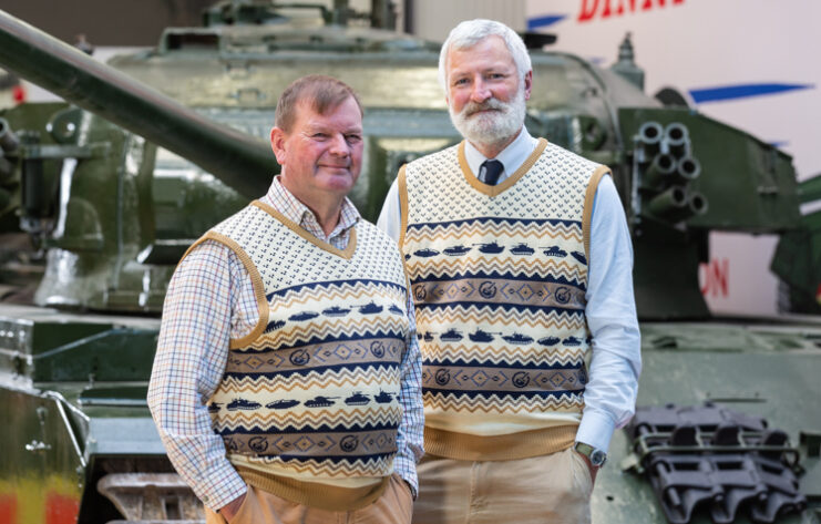 Two staff members with The Tank Museum wearing Christmas vests