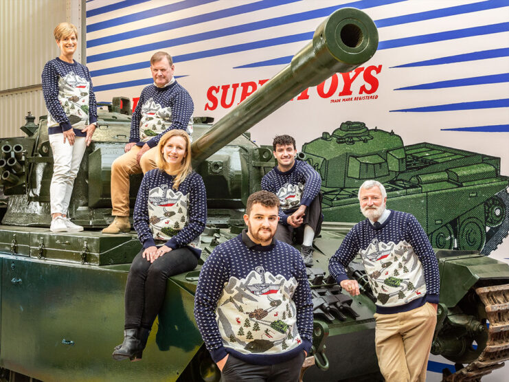 Six staff members with The Tank Museum wearing Christmas jumpers