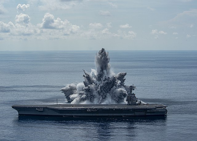 Explosion occurring in the water near the USS Gerald R Ford (CVN-78)