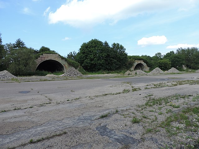 Two concrete structures along the edge of a former runway