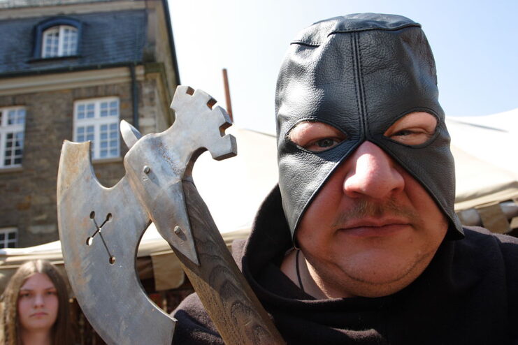 Man dressed as a medieval execution, holding an axe