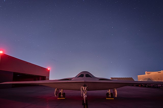 Northrop Grumman B-21 Raider parked on the tarmac at dusk