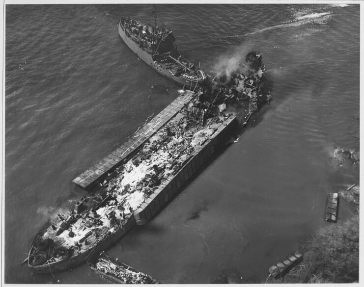 Aerial view of the smouldering remains of the USS LST-480