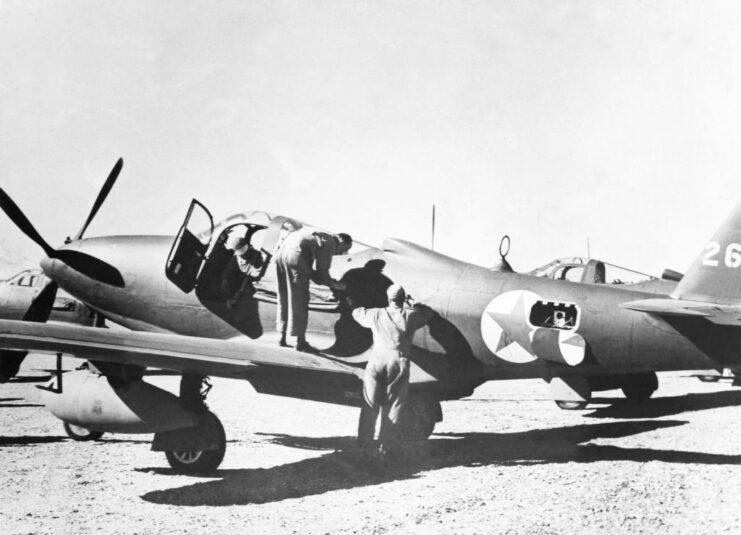 Mechanics working on a grounded Bell P-63 Kingcobra