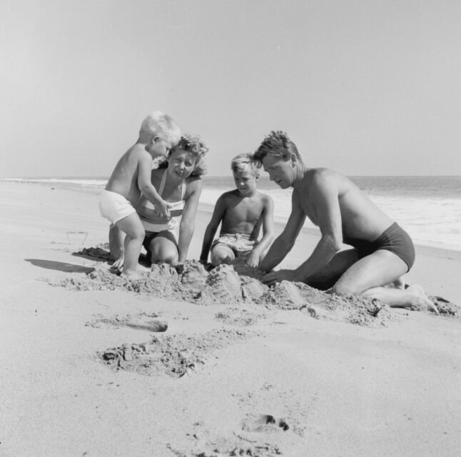 Lloyd and Dorothy Bridges playing on the beach with their sons, Beau and Jeff