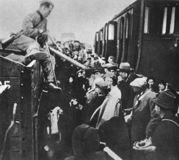 Jewish individuals being forced into train cars