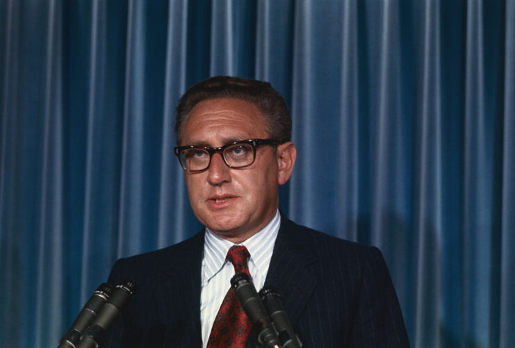 Henry Kissinger speaking at a podium