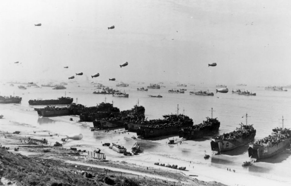 Barrage balloons and ships along the coast of Omaha Beach