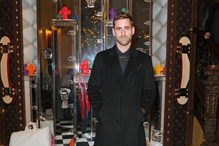 Oliver Jackson-Cohen standing in a Louis Vuitton store