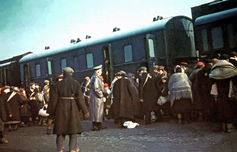 Jewish individuals being forced into train cars
