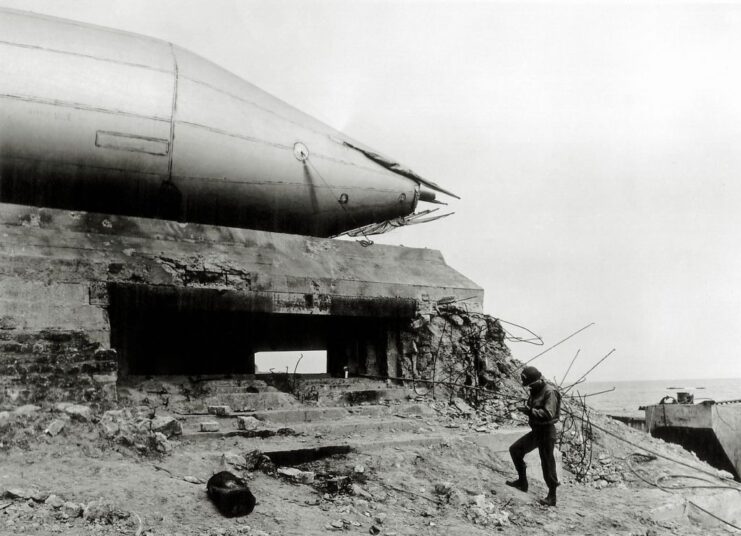 Soldier standing near a barrage balloon resting on Widerstandsnest 72 (Wn 72)