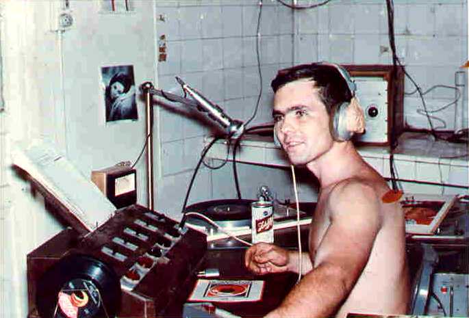 Spc. Tim Abney sitting in front of radio equipment