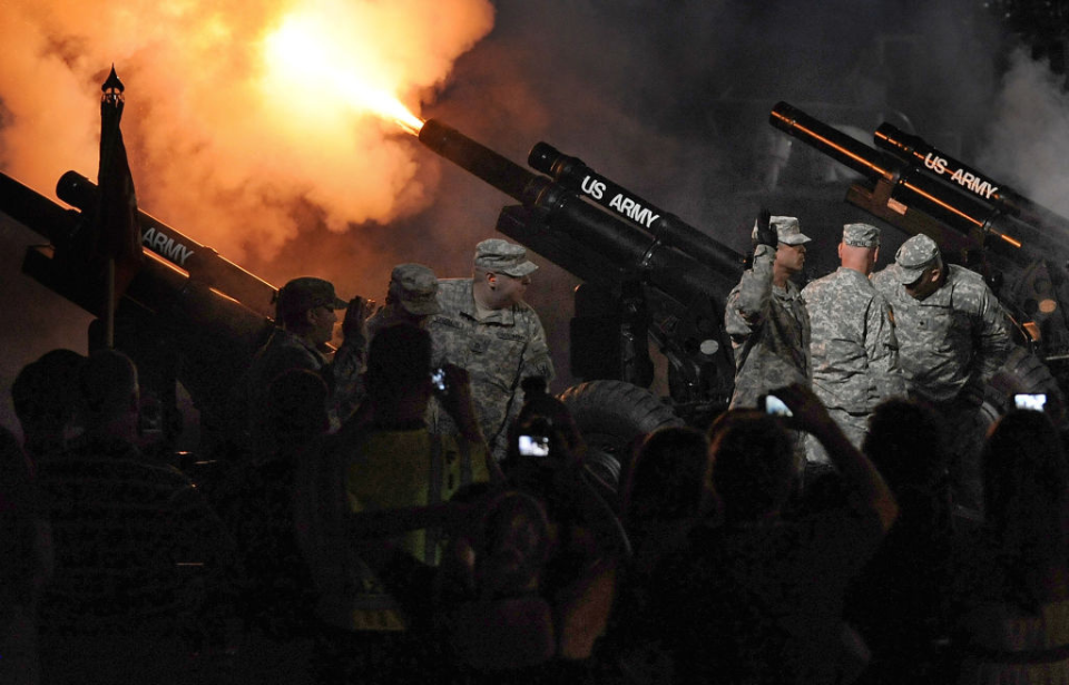 US Army soldiers firing a 105 mm Howitzer
