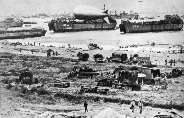 Ships, vehicles and personnel along one of the Normandy beaches