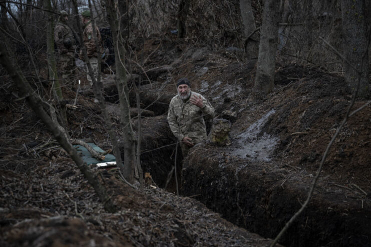 Ukrainian soldier standing in the middle of a trench