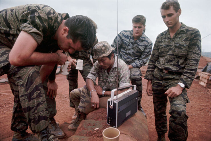 Members of the Special Forces-CIDG and US Artillery Battery gathered around a portable radio