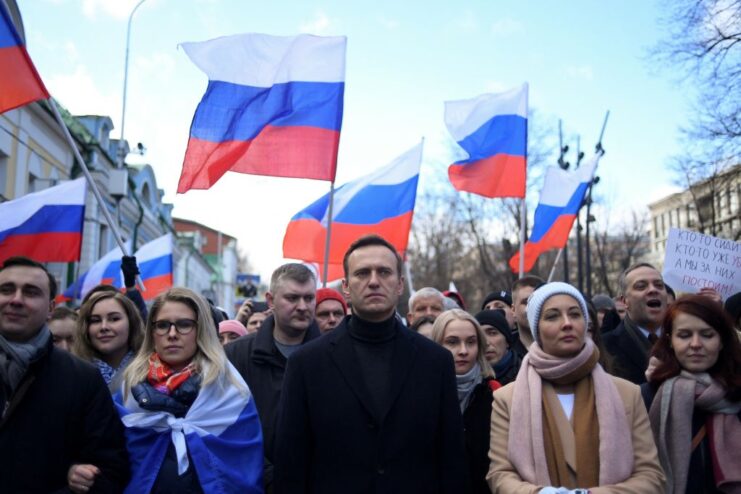 Alexei Navalny standing with a crowd of demonstrators