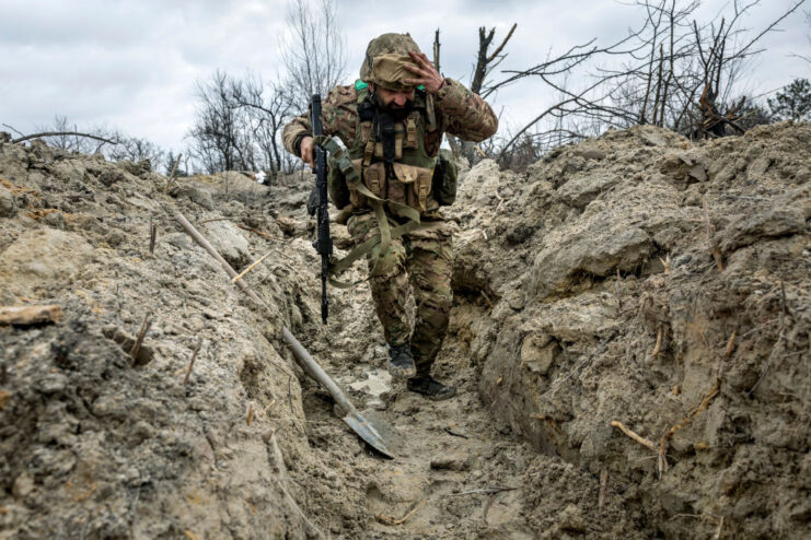 Ukrainian military medic running through a trench