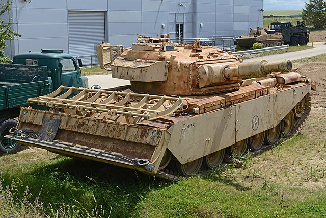 Centurion FV4003 AVRE parked near a building