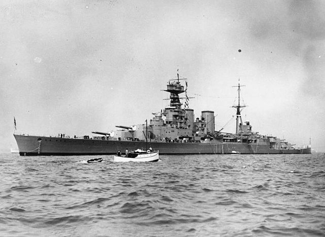 Small boat moving near the HMS Hood (51) at sea