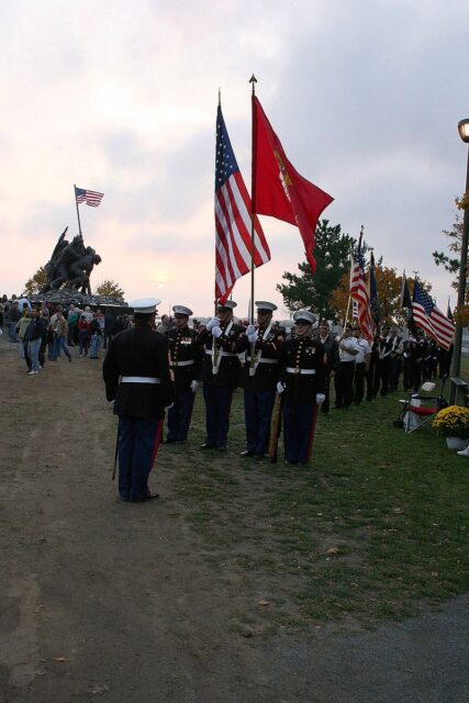 Members of the US Marine Corps Color Guard, Cape Cod and Islands Detachment 955, standing near the Iwo Jima Memorial in Fall River, Massachusetts