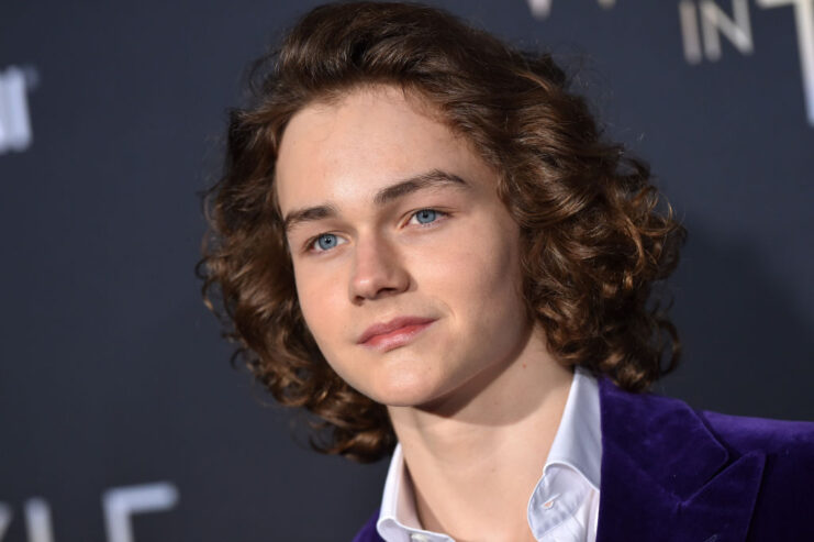 Levi Miller standing on a red carpet