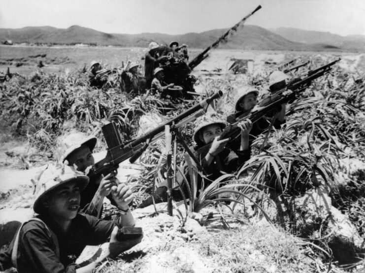 North Vietnamese Army soldiers aiming their weapons at the sky