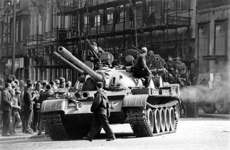 Soldiers sitting on the exterior of a T-55