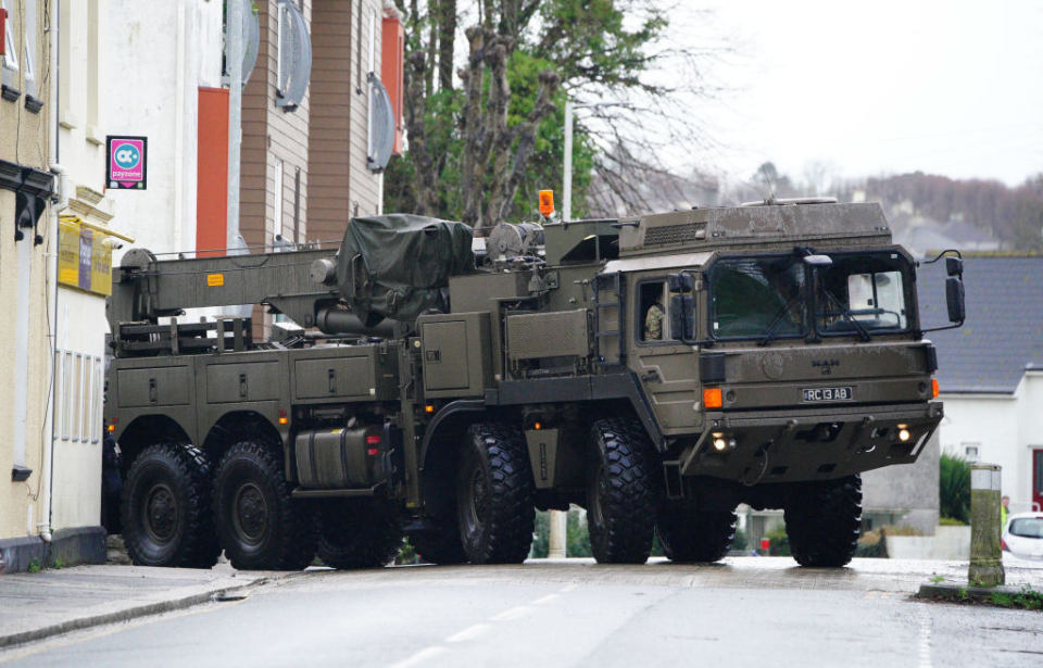 Military vehicle parked in the middle of a street