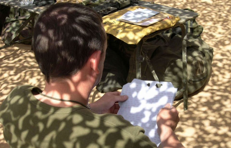British soldier reading a letter outside