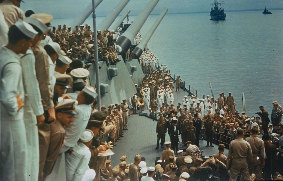 Allied and Japanese military personnel standing on the deck of the USS Missouri (BB-63)