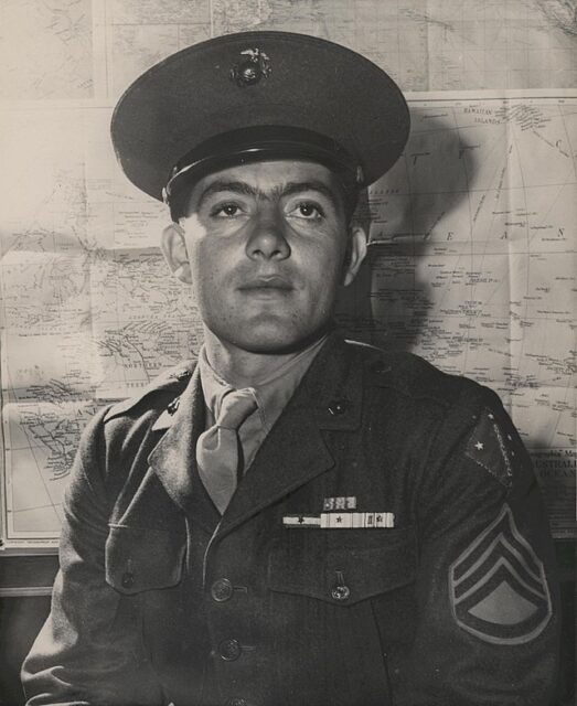 John Basilone sitting in his US Marine Corps uniform