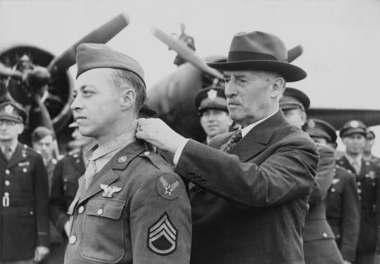 Henry L. Stimson placing the Medal of Honor around Maynard Harrison Smith's neck