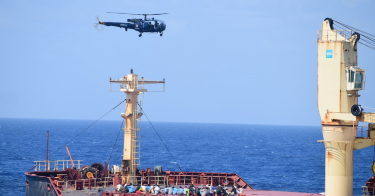 Helicopter hovering over the MV Ruen at sea