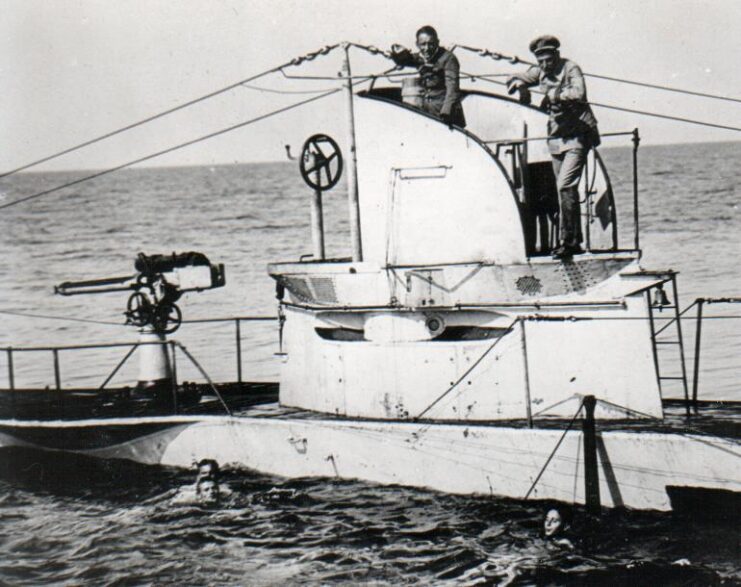 Two crewmen standing atop the SM U-27 at sea