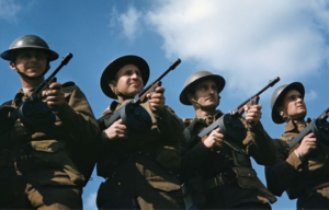 Four British infantrymen holding Tommy Guns