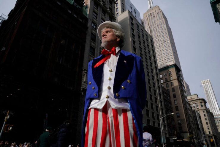 Man dressed as Uncle Sam standing in the middle of a city street